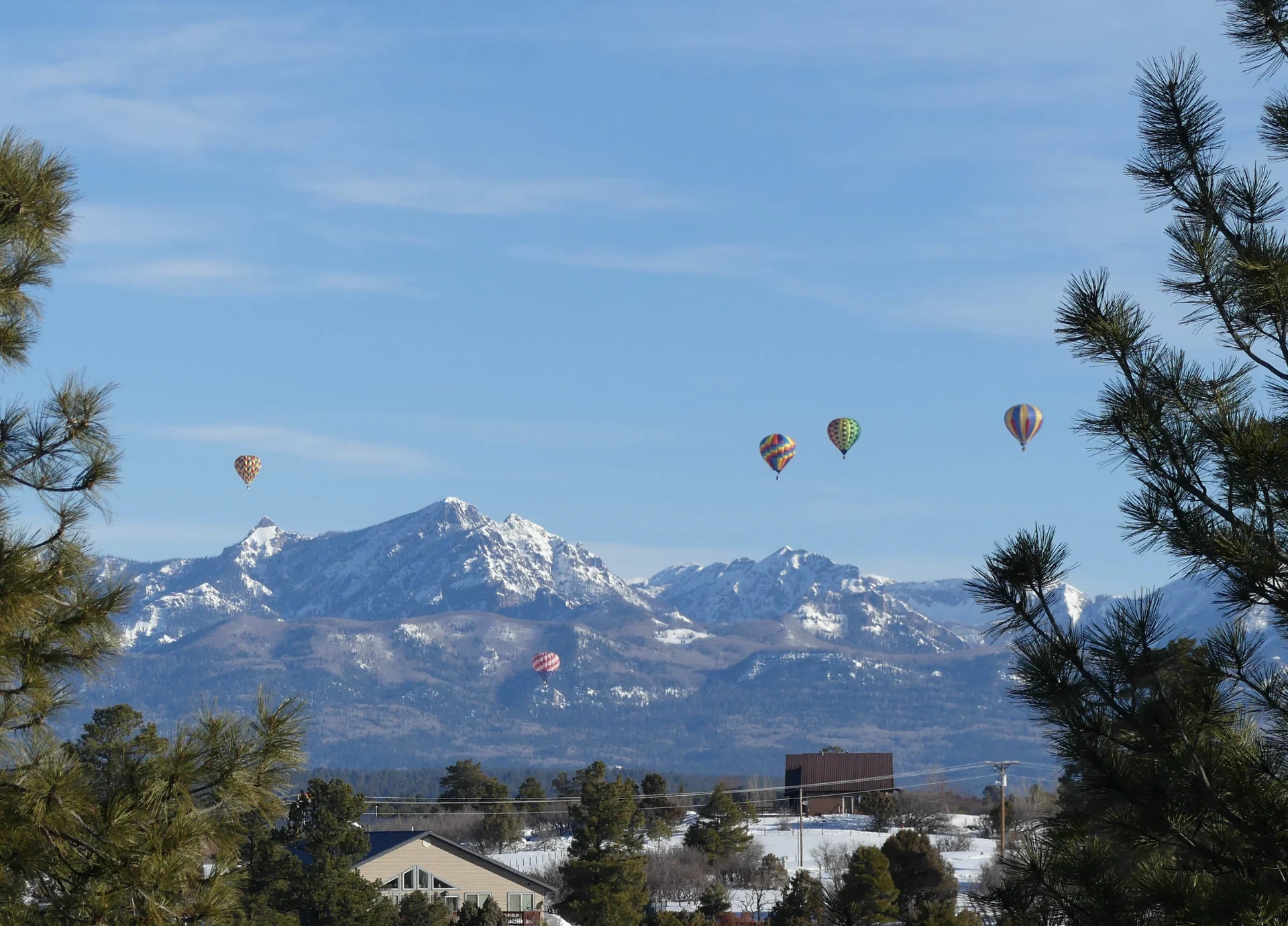 Hot air balloons over snowy peaks near Pagosa Springs